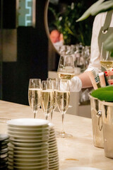 waiter pouring champagne into a wineglass at a wedding reception