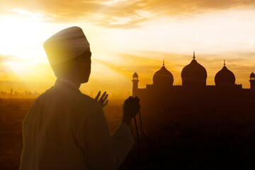 Silhouette of muslim man worship and praying
