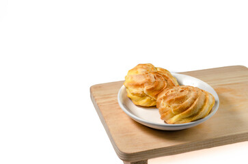 Soes Cake also known as Choux Pastry displayed on a wooden plate