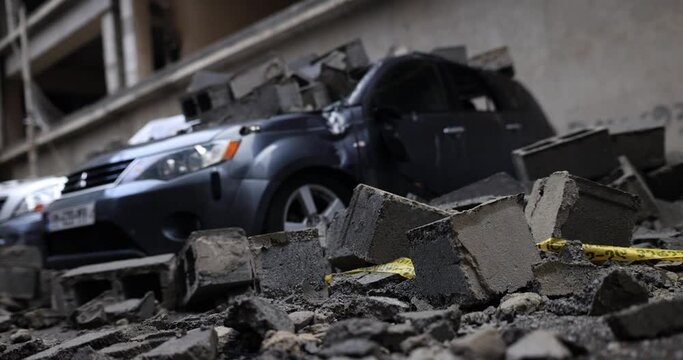 Concrete blocks on a broken car and broken glass