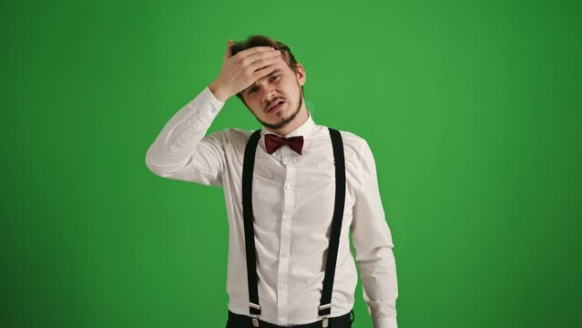 Young Man with Headache on Green Background