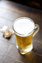 Glass of beer on wooden background. Copy space.	