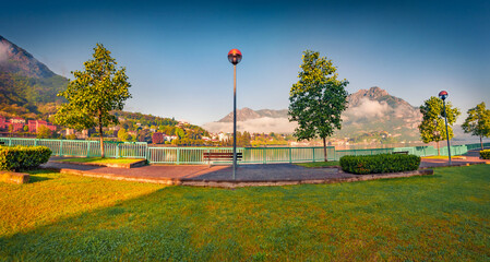 Panoramic summer view of public park of Lecco town with Resegone peak on background, Italy, Europe....
