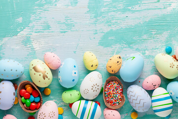 Colorful Easter Egg bottom border over a blue wooden background.