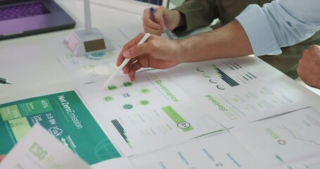 Closeup group Asia businesspeople talk ESG strategies risk management workshop, SDGs report, global warming, green finance investment eco friendly and net zero waste in boardroom training building.