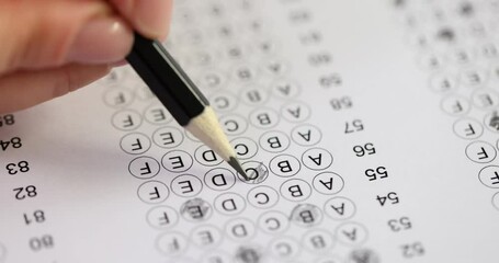 Female hand testing hand on test exam with pencil