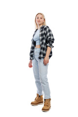 A teenage girl is standing. A cute blonde with freckles on her face wearing jeans, a plaid shirt and yellow shoes. Full height. Isolated on a white background. Vertical.