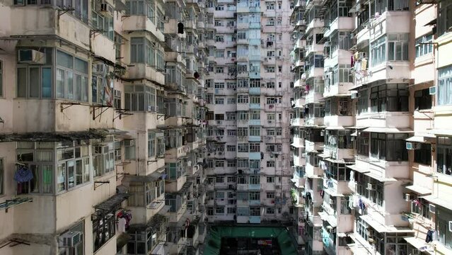 Monster building Montane Mansion in Quarry Bay Hong Kong, consists of several tightly packed buildings with window grilles, canopies, and air-conditioning ,an old residential units are well-proportion