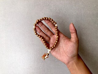 Praying beads or tasbih on gold. Plain background