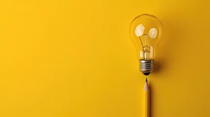Fotobehang a yellow light bulb with a pencil sticking out of it on a yellow background with a shadow of a pencil. © Olga