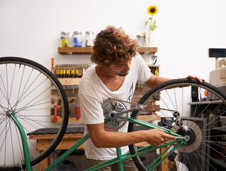 Small business, startup and bike repair with man mechanic in workshop for service or maintenance....