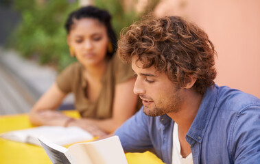 Face, education and student man reading on college or university campus for learning and study....