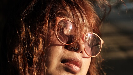 portrait of a person with glasses in sunlight