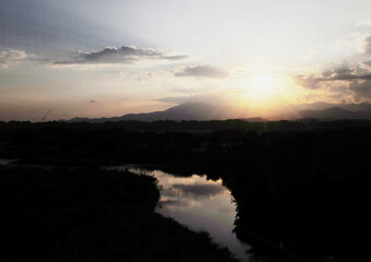 Sunset sky with clouds and river 雲の広がる夕焼け空、そして川