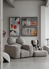 Stylish living space featuring a comfortable modern sofa, unique art pieces on the wall, and trendy designer toys