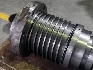 A shaft after machining on the lathe and CNC milling machine lies on the pallet  