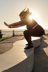 Energetic Woman Practicing Outdoor Fitness at Sunrise