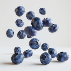Electric blue fruit falling on white surface, like natural art