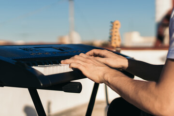 man playing piano on an urban rooftop