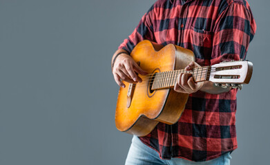 Music lifestyle man playing guitar. Playing an acoustic guitar. Guitarist hands and guitar. Man's...