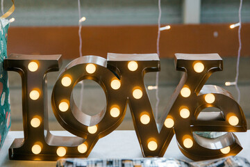 The word love written with light bulbs in the form of letters.
