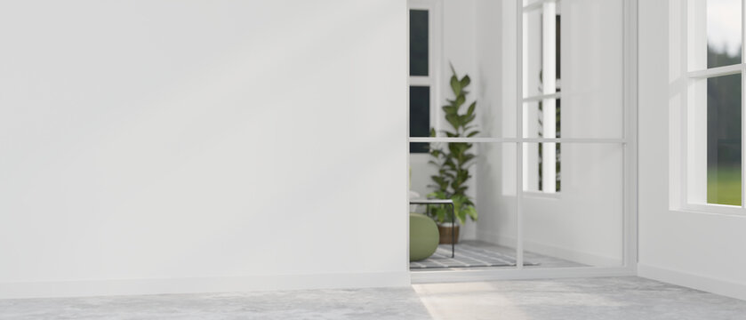 A modern home corridor in front of a living room features a white wall.