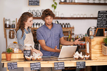 Fototapeta premium Laptop, bakery and small business people with website for social media ideas, planning and advice of startup. Young woman and man confused or questions on computer for e commerce registration of cafe