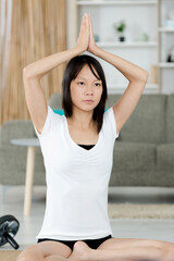 young woman does yoga at home