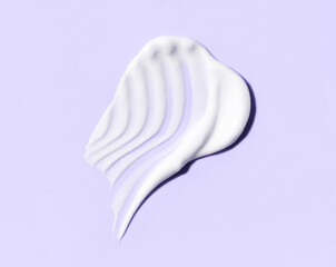 cosmetic smear of creamy texture on pastel background