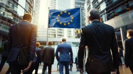 Schilderijen op glas European Union politics concept image with back view of formal unrecognizable politicians at EU parliament in front of the European Union flag © Keitma