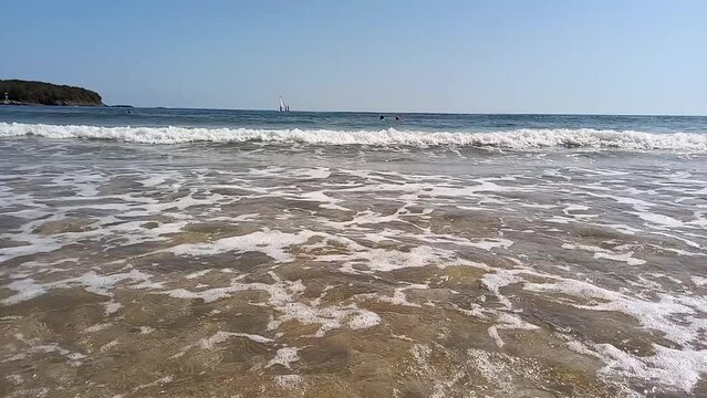 Seascape. People relaxing and swiming in sea on hot summer day. Active recreation, windsurfing in Bulgaria on Black Sea coast. Perla beach in Primorsko.