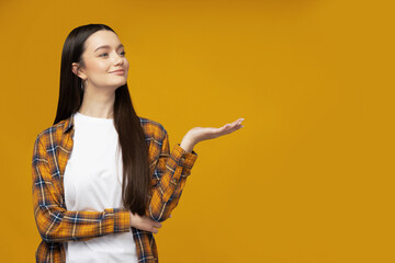 Attractive young woman posing on a yellow background