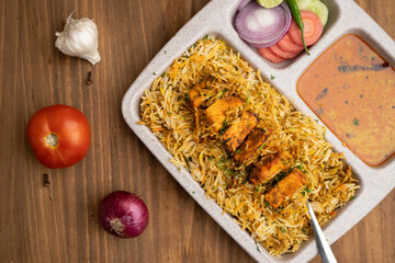 Paneer tikka biryani with onion raitha, vegetable biryani, hyderabadi biryani, south indian biryani served in plate