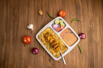 Paneer tikka biryani with onion raitha, vegetable biryani, hyderabadi biryani, south indian biryani served in plate