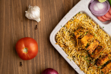 Paneer tikka biryani with onion raitha, vegetable biryani, hyderabadi biryani, south indian biryani served in plate
