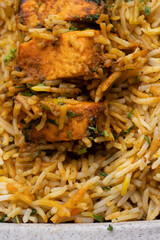 Paneer tikka biryani with onion raitha, vegetable biryani, hyderabadi biryani, south indian biryani served in plate