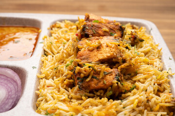 Paneer tikka biryani with onion raitha, vegetable biryani, hyderabadi biryani, south indian biryani served in plate