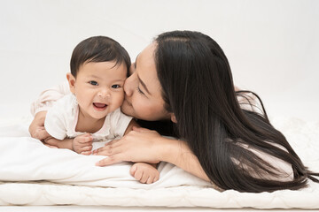 Beautiful mom and daughter smiling and  taking photo on isolated backgrould.