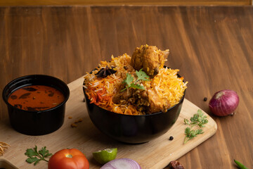 Restaurant style Spicy Chicken Biryani served with Raita and Salan, Popular Indian or Pakistani non...