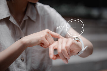 nonstop service concept. businessman hand holding virtual 24-7 with clock on hand for smart phone nonstop and full-time available contact of service concept. customer service.