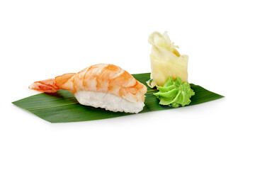 Shrimp sushi nigiri with wasabi and pickled ginger on bamboo leaf