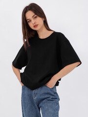 mockup of a black loose-fitting t-shirt on a young beautiful girl