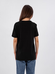 mockup of a black loose-fitting t-shirt on a young beautiful girl