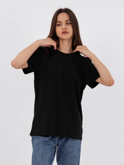 mockup of a black loose-fitting t-shirt on a young beautiful girl