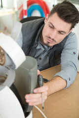 professional young repairman fixing coffee machine