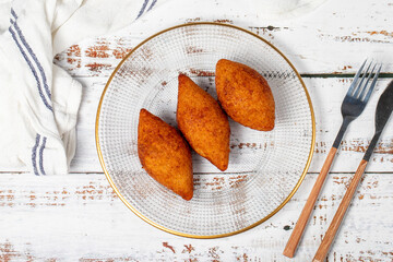 Stuffed meatballs or kibbeh. Traditional Asian flavors. Delicious meatballs filled with minced meat. Kibbeh on white wood background. local name içli köfte. Top view