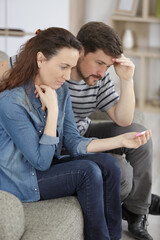 Fototapeta na wymiar despondent couple are looking at pregnancy test
