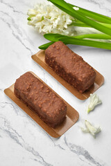 Artisan chocolate nut loaf cakes on marble with white hyacinth