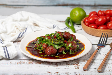 Aleppo meatballs. Traditional Asian flavors. Meatballs with tomato paste. Aleppo meatballs on white wood background