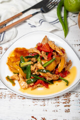 Chicken salad. Traditional Asian flavours. Salad made with boiled chicken and vegetables. Chicken salad appetizer on a white wood background